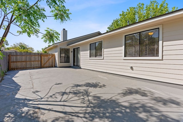 11500 Ruffed Grouse Dr, Austin, TX 78758 - rear view of property with a chimney, fence, and a patio
