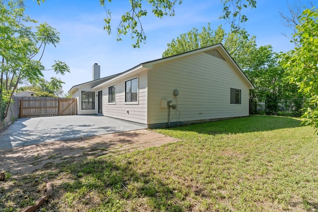 11500 Ruffed Grouse Dr, Austin, TX 78758 - rear view of property with a chimney and a patio area