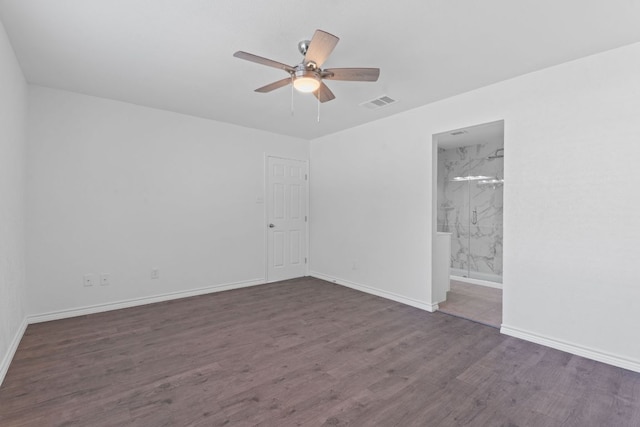 11500 Ruffed Grouse Dr, Austin, TX 78758 - unfurnished bedroom featuring wood finished floors, baseboards, ceiling fan, and connected bathroom