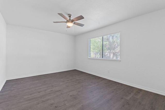 11500 Ruffed Grouse Dr, Austin, TX 78758 - spare room featuring dark wood-style floors, ceiling fan, and baseboards