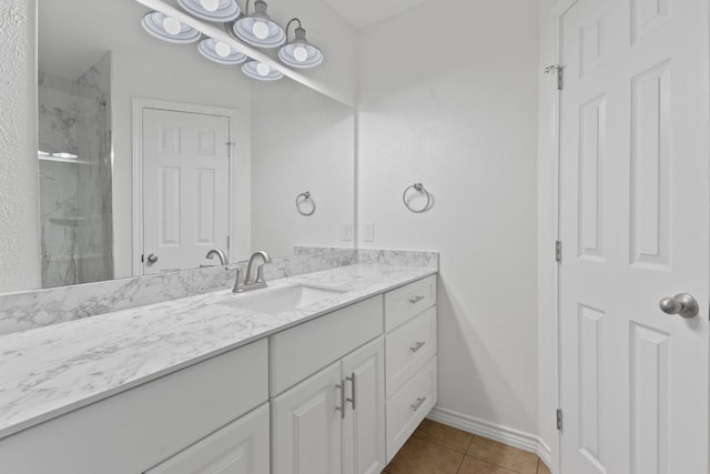11500 Ruffed Grouse Dr, Austin, TX 78758 - bathroom featuring vanity, tile patterned flooring, a marble finish shower, and baseboards