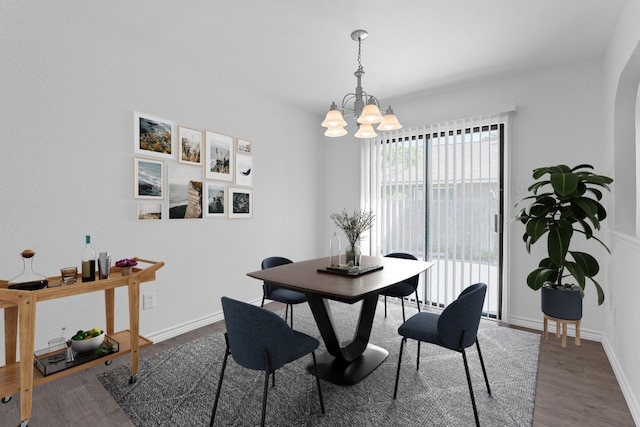 11500 Ruffed Grouse Dr, Austin, TX 78758 - dining area featuring a chandelier, wood finished floors, and baseboards