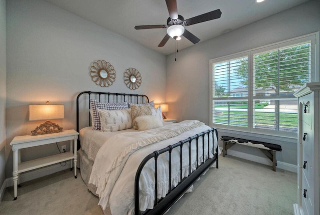bedroom with baseboards, multiple windows, and carpet floors