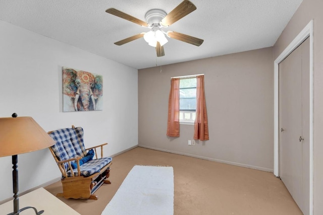 2600 Donna Dr, Taylor, TX 76574 - sitting room featuring a ceiling fan, carpet flooring, and a textured ceiling