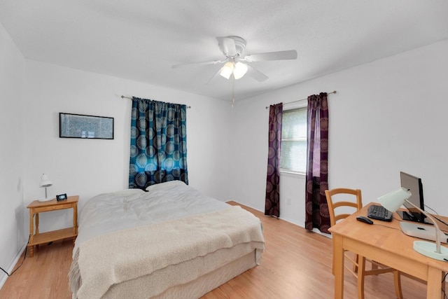2600 Donna Dr, Taylor, TX 76574 - bedroom featuring light wood-type flooring, an office area, baseboards, and ceiling fan