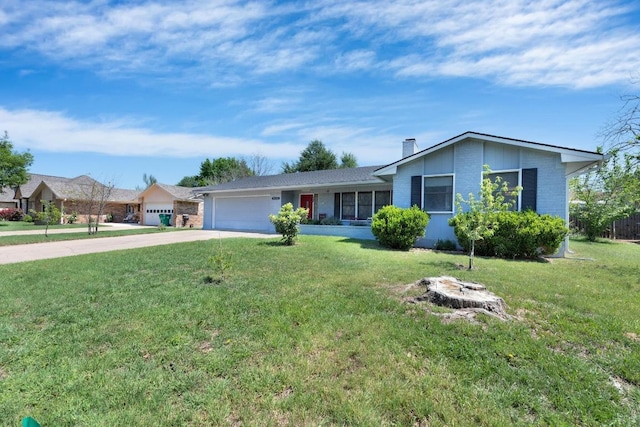 2600 Donna Dr, Taylor, TX 76574 - ranch-style home featuring concrete driveway, an attached garage, brick siding, and a front lawn