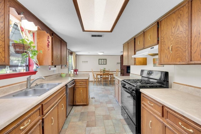 2600 Donna Dr, Taylor, TX 76574 - kitchen featuring black gas range oven, under cabinet range hood, dishwasher, a sink, and brown cabinets