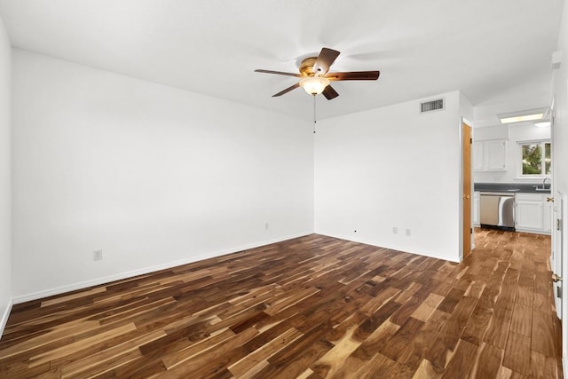 21459 Coyote Trl Unit B4, Lago Vista, TX 78645 - empty room with a ceiling fan and dark wood-style flooring
