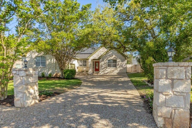 8312 Jancy Dr, Austin, TX 78750 - view of front of property with roof mounted solar panels and stone siding