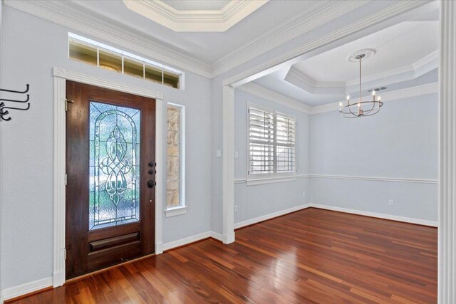 8312 Jancy Dr, Austin, TX 78750 - foyer entrance with a tray ceiling, plenty of natural light, wood finished floors, a chandelier, and ornamental molding