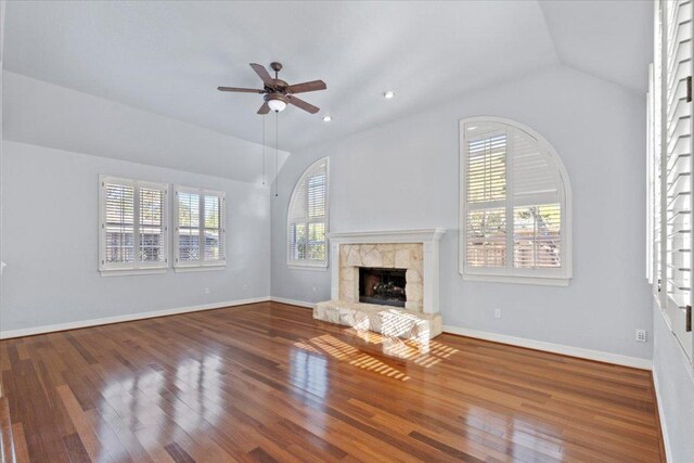 8312 Jancy Dr, Austin, TX 78750 - unfurnished living room featuring vaulted ceiling, a stone fireplace, ceiling fan, wood finished floors, and recessed lighting