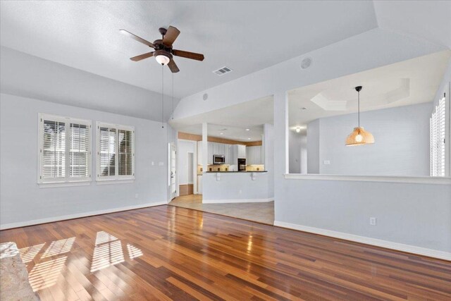 8312 Jancy Dr, Austin, TX 78750 - unfurnished living room with a ceiling fan, light wood finished floors, and plenty of natural light