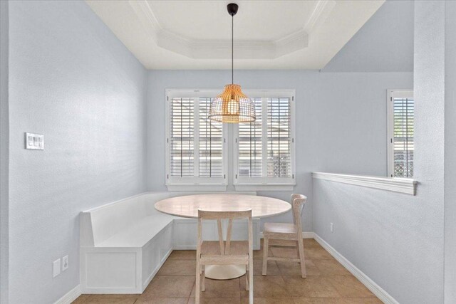 8312 Jancy Dr, Austin, TX 78750 - dining room with breakfast area, crown molding, a raised ceiling, and light tile patterned floors