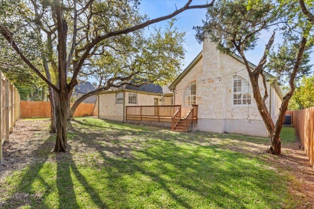 8312 Jancy Dr, Austin, TX 78750 - back of house featuring a fenced backyard, a wooden deck, and stone siding