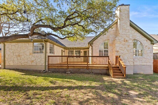 8312 Jancy Dr, Austin, TX 78750 - back of property featuring stone siding, a deck, a chimney, and a yard