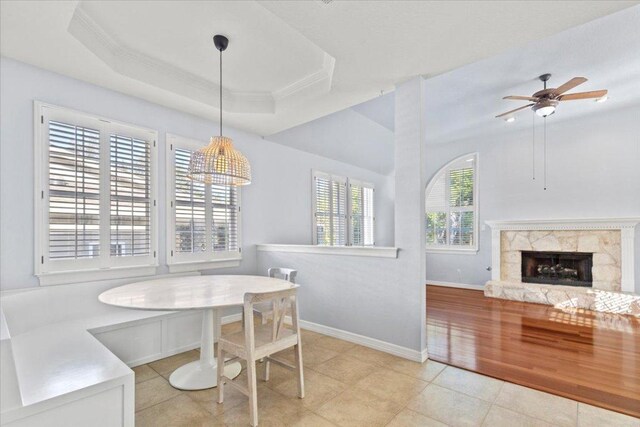 8312 Jancy Dr, Austin, TX 78750 - dining space featuring a tray ceiling, ceiling fan, a high end fireplace, ornamental molding, and light tile patterned floors