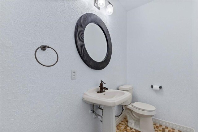 8312 Jancy Dr, Austin, TX 78750 - bathroom featuring baseboards and toilet