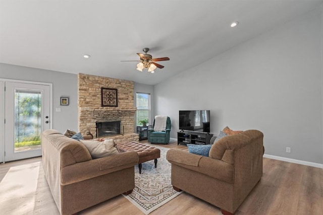 11605 Gunsmoke Cir, Austin, TX 78750 - living area with healthy amount of natural light, light wood-style floors, a ceiling fan, a stone fireplace, and vaulted ceiling