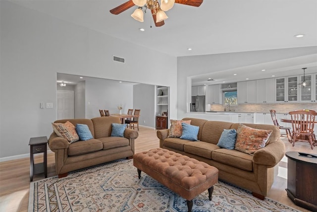 11605 Gunsmoke Cir, Austin, TX 78750 - living area featuring lofted ceiling, ceiling fan, light wood-type flooring, recessed lighting, and baseboards