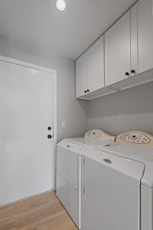 11605 Gunsmoke Cir, Austin, TX 78750 - laundry room with cabinet space, independent washer and dryer, and light wood-type flooring