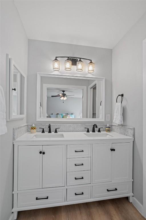 11605 Gunsmoke Cir, Austin, TX 78750 - full bathroom featuring double vanity, wood finished floors, and a ceiling fan