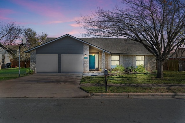 11605 Gunsmoke Cir, Austin, TX 78750 - view of front of property with an attached garage, driveway, a front yard, and brick siding