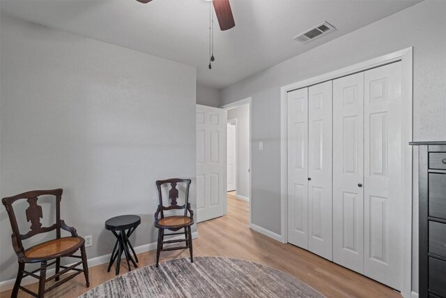 11605 Gunsmoke Cir, Austin, TX 78750 - living area with wood finished floors, ceiling fan, and baseboards