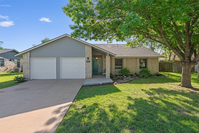 ranch-style house with fence, an attached garage, a front lawn, cooling unit, and driveway