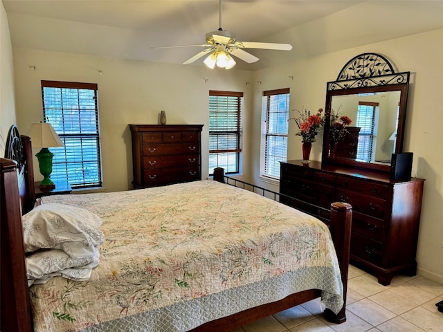 bedroom with light tile patterned floors, baseboards, and a ceiling fan