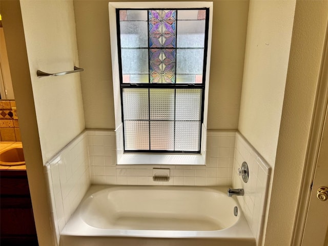 bathroom featuring wainscoting, a garden tub, and a healthy amount of sunlight