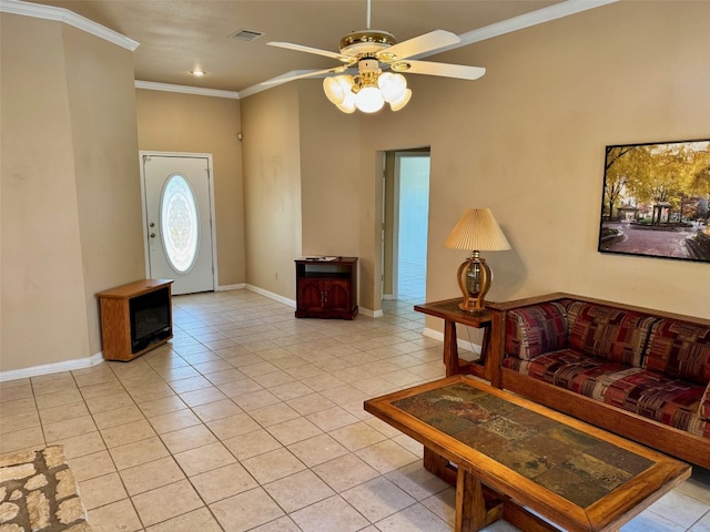 living room featuring baseboards, light tile patterned floors, a ceiling fan, crown molding, and visible vents