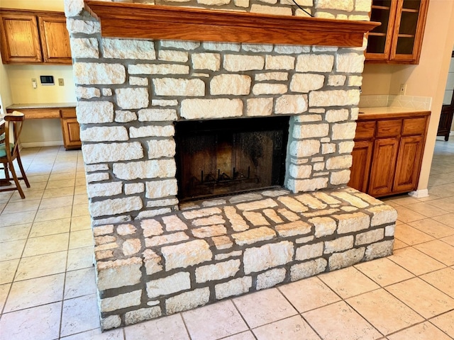 interior details featuring a stone fireplace