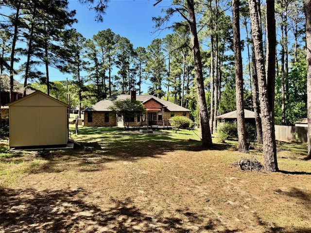 view of yard featuring an outbuilding and a storage unit