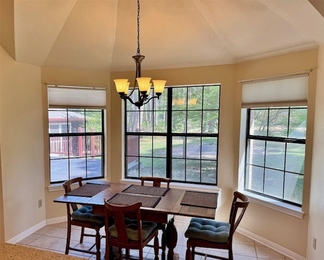 dining area with an inviting chandelier, vaulted ceiling, light tile patterned floors, and a wealth of natural light