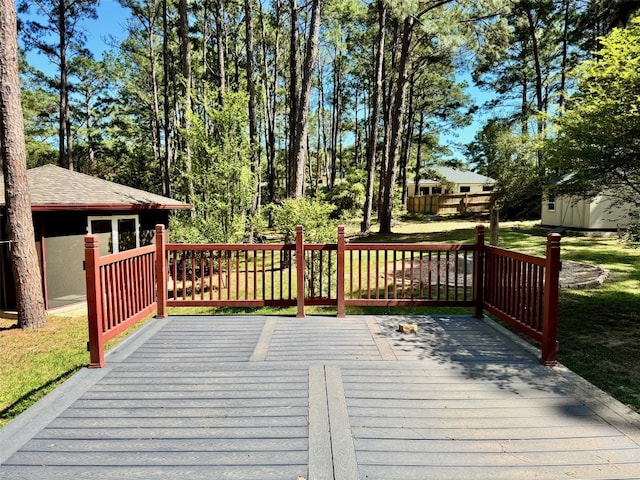 wooden terrace with a lawn