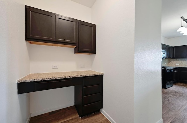234 Coleto Creek Loop, Kyle, TX 78640 - unfurnished office featuring wood finished floors, built in study area, and baseboards