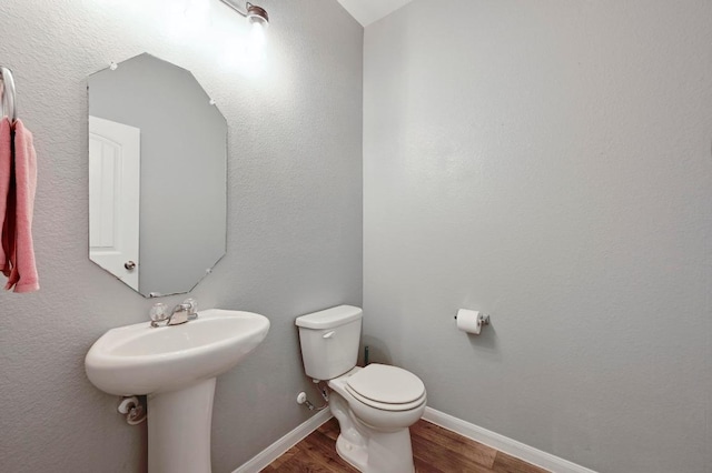 234 Coleto Creek Loop, Kyle, TX 78640 - half bath with wood finished floors, toilet, baseboards, and a sink