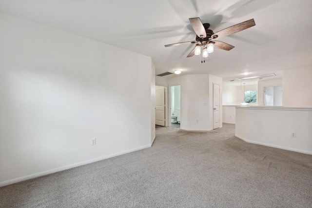 234 Coleto Creek Loop, Kyle, TX 78640 - unfurnished room with light carpet, baseboards, a ceiling fan, and attic access