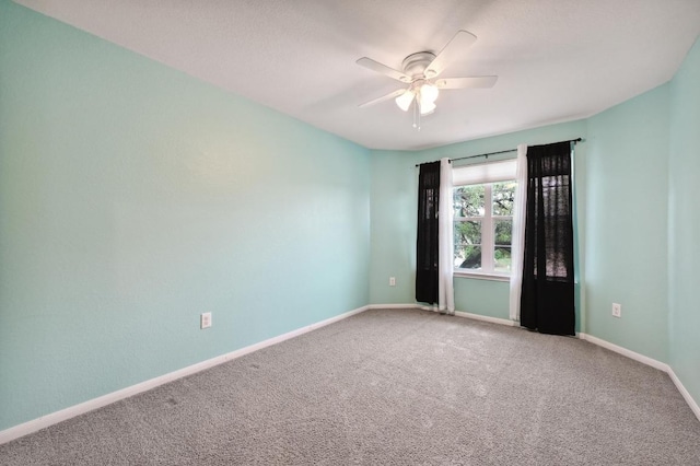 234 Coleto Creek Loop, Kyle, TX 78640 - empty room with carpet flooring, a ceiling fan, and baseboards