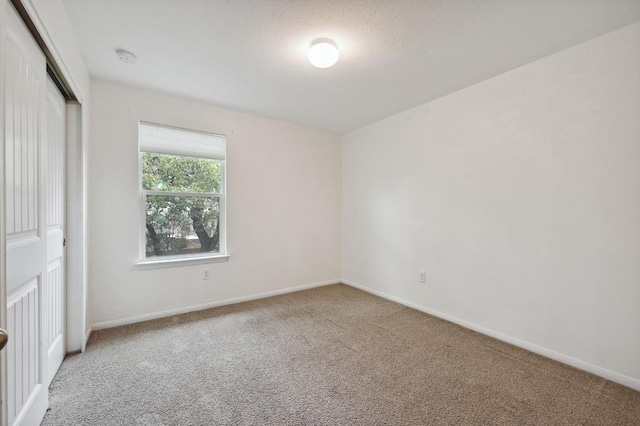 234 Coleto Creek Loop, Kyle, TX 78640 - unfurnished bedroom featuring carpet, a closet, and baseboards