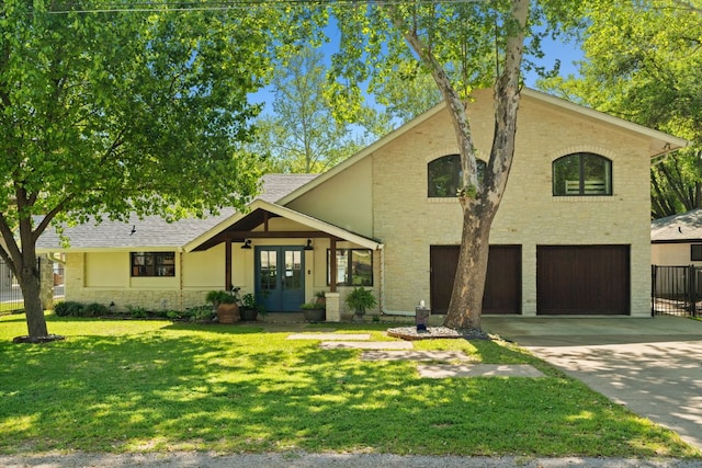 1001 Lakeshore Dr, Marble Falls, TX 78654 - view of front facade featuring french doors, a garage, concrete driveway, and brick siding