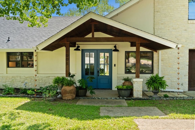 1001 Lakeshore Dr, Marble Falls, TX 78654 - entrance to property with stucco siding, a lawn, roof with shingles, stone siding, and french doors