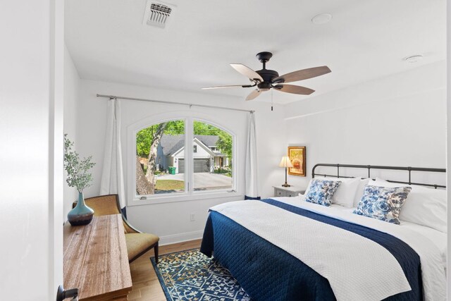 1001 Lakeshore Dr, Marble Falls, TX 78654 - bedroom with wood finished floors, baseboards, a ceiling fan, and visible vents