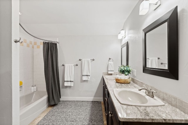 1001 Lakeshore Dr, Marble Falls, TX 78654 - bathroom featuring shower / bath combo, double vanity, a sink, and baseboards