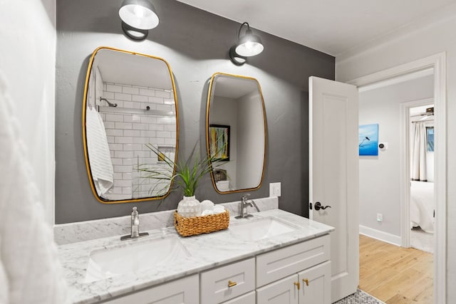 1001 Lakeshore Dr, Marble Falls, TX 78654 - full bath featuring a sink, baseboards, double vanity, and wood finished floors