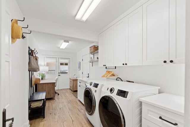 1001 Lakeshore Dr, Marble Falls, TX 78654 - washroom featuring light wood-type flooring, independent washer and dryer, and cabinet space