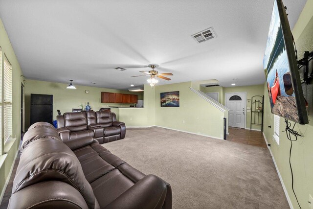 6829 Walkup Ln, Austin, TX 78747 - carpeted living room featuring visible vents, ceiling fan, and baseboards