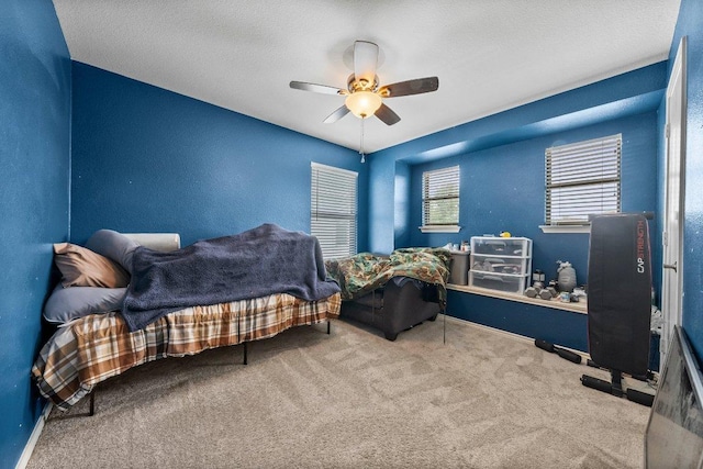 carpeted bedroom featuring a ceiling fan and baseboards