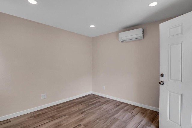 15811 De Peer Cv, Austin, TX 78717 - unfurnished room featuring a wall unit AC, wood finished floors, and recessed lighting