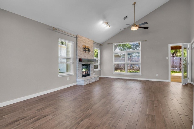 15811 De Peer Cv, Austin, TX 78717 - unfurnished living room featuring a ceiling fan, a fireplace, dark wood-type flooring, plenty of natural light, and high vaulted ceiling
